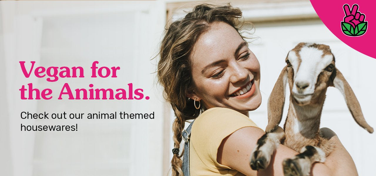 Photograph of a smiling young woman holding a baby goat. The image says, "Vegan for the Animals: Check out our animal themed housewares!"